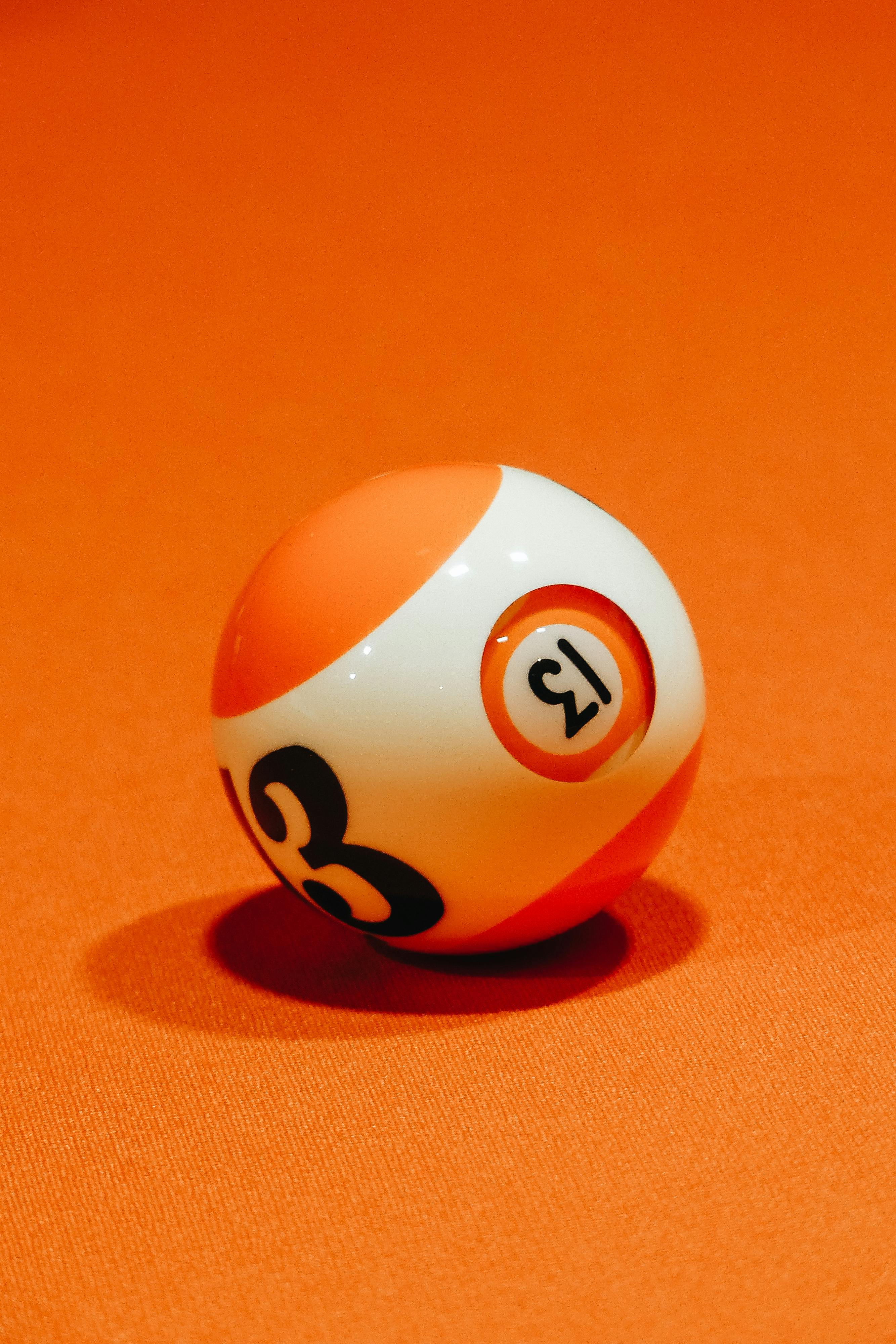 Number 13 billiard ball on an orange background