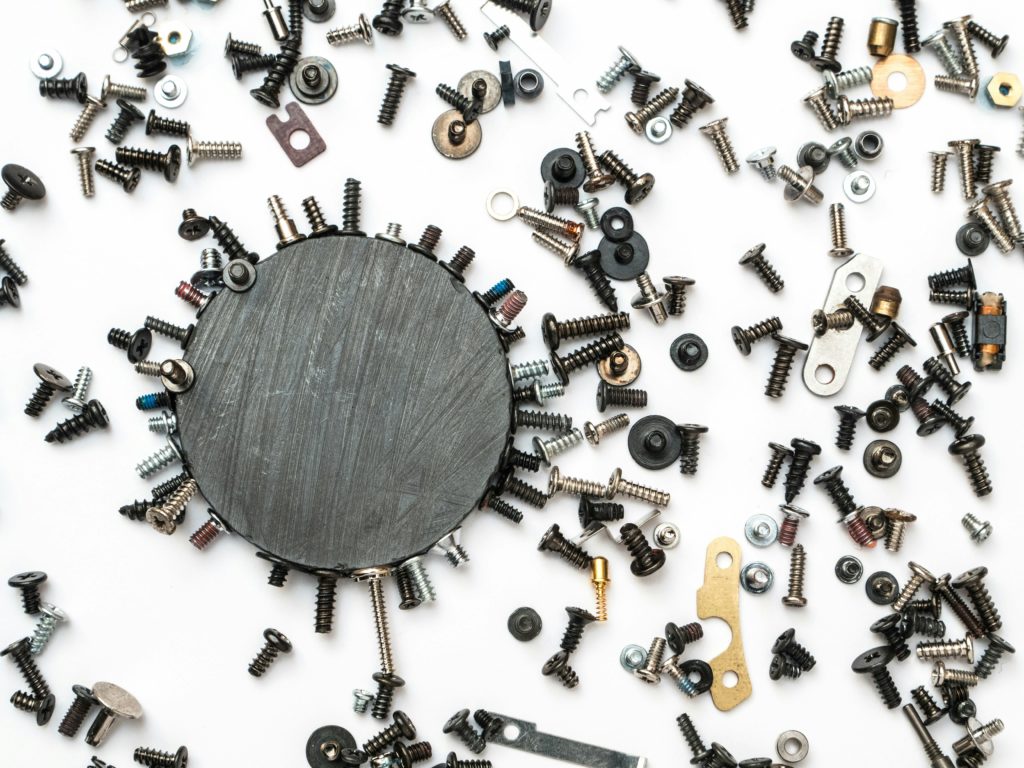 newly machined screws, washers, bolts, etc scattered on a surface