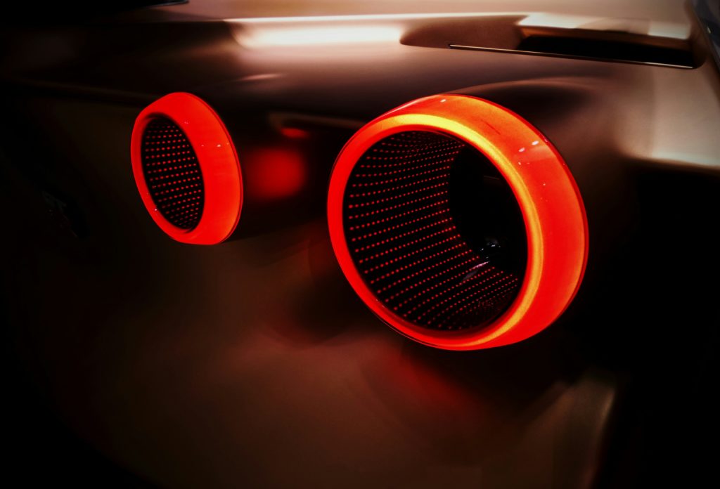 close up of two illuminated red speakers (or perhaps microphones!) on a car