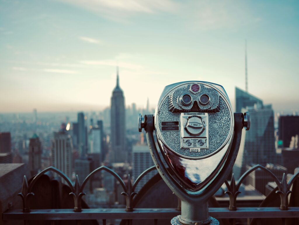coin operated binoculars on a rooftop overlooking New York City.