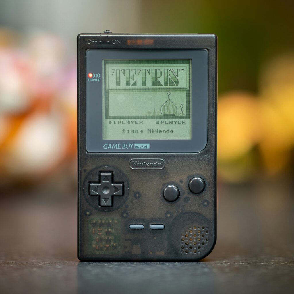 transparent grey Nintendo Game Boy Pocket booted up with the Tetris game home screen with copyright 1989