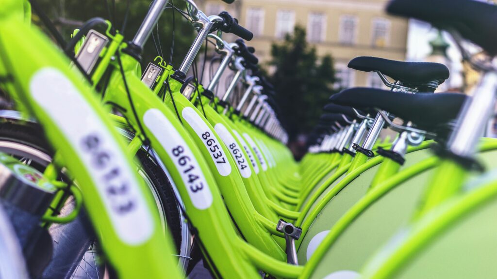 A multitude of green rental bikes.