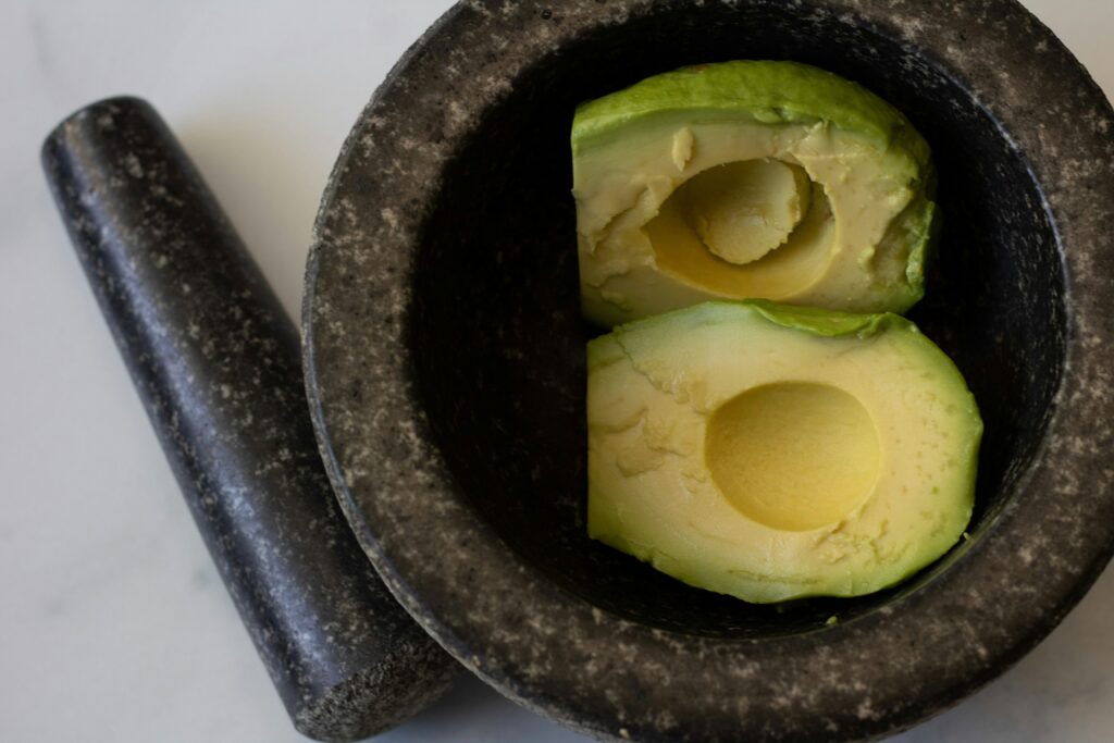 mortar, pestle and avocado preparation for guacamole