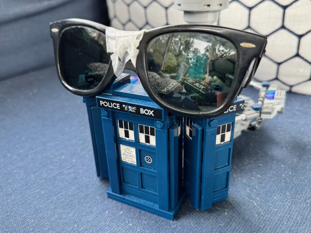 Taped up sunglasses on top of a LEGO Tardis