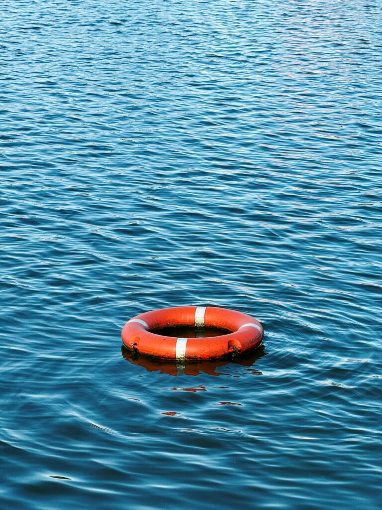 Orange lifebouy ring floating on water
